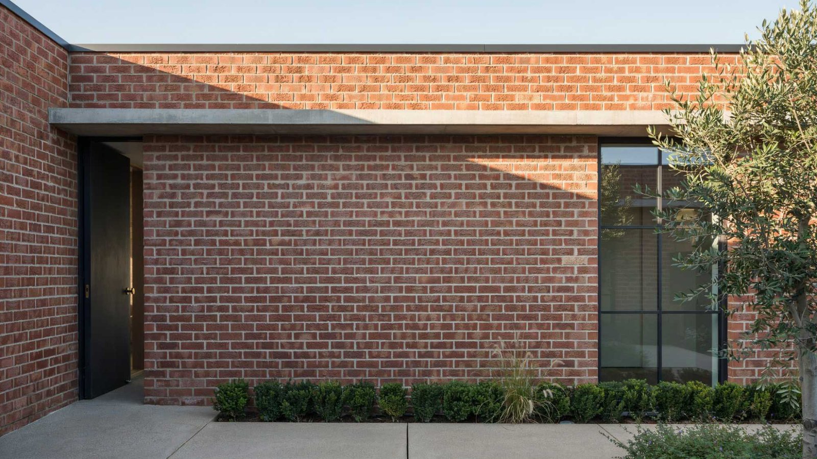 Face brick wall showing smooth finish, uniform shape, and attractive appearance for exposed building surfaces.