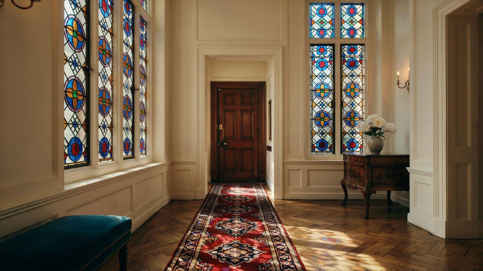 Beautiful stained glass multi-paned windows with colorful artistic designs in a classic classy home.