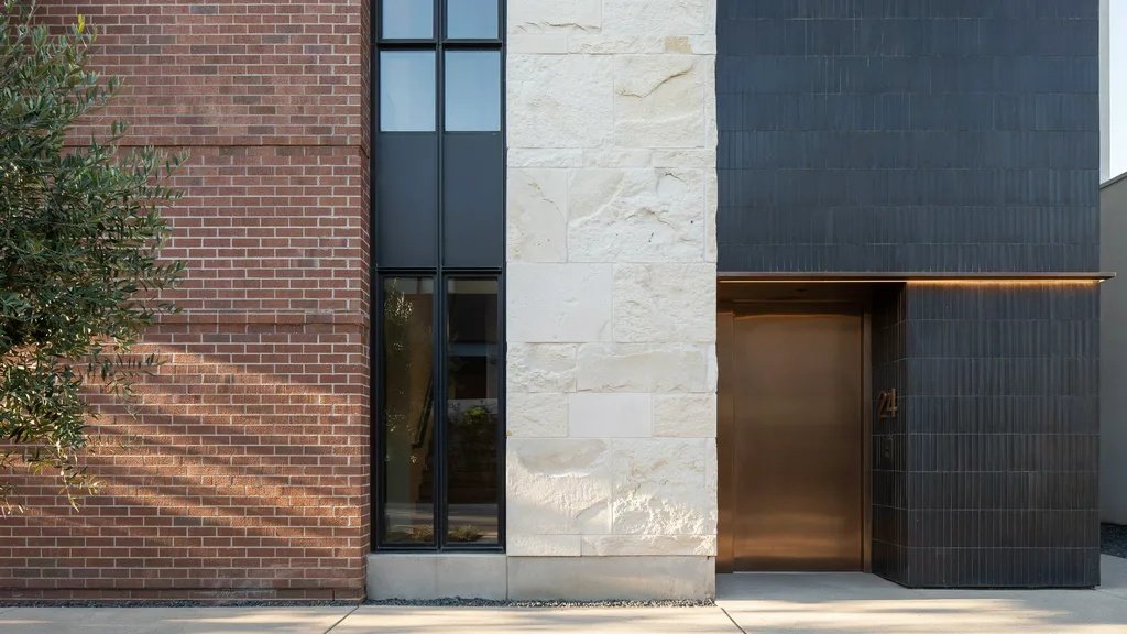Building facade featuring brick, stone, and ceramic cladding materials.
