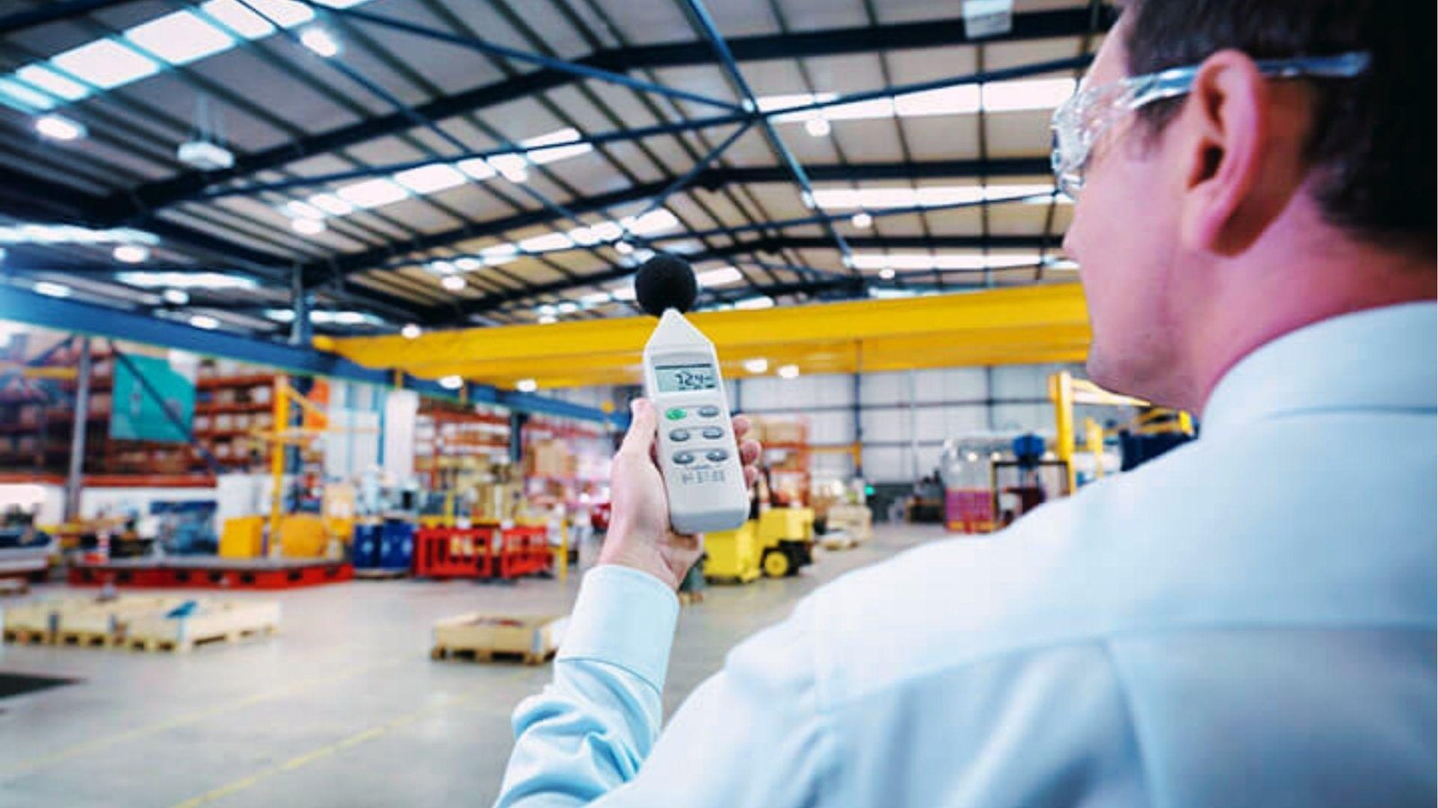 Inspector uses a sound meter in the warehouse to check the acoustic performance of building envelope systems.