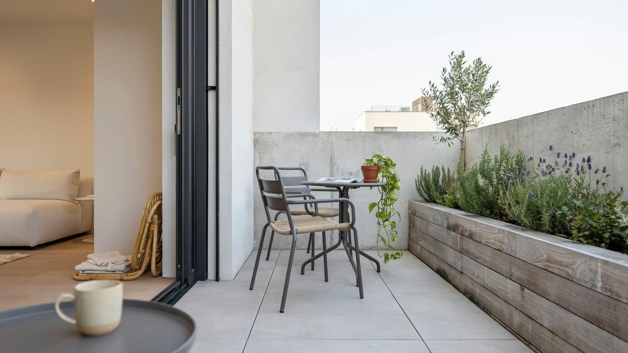 Compact patio area featuring a sliding glass door to maximize available space.