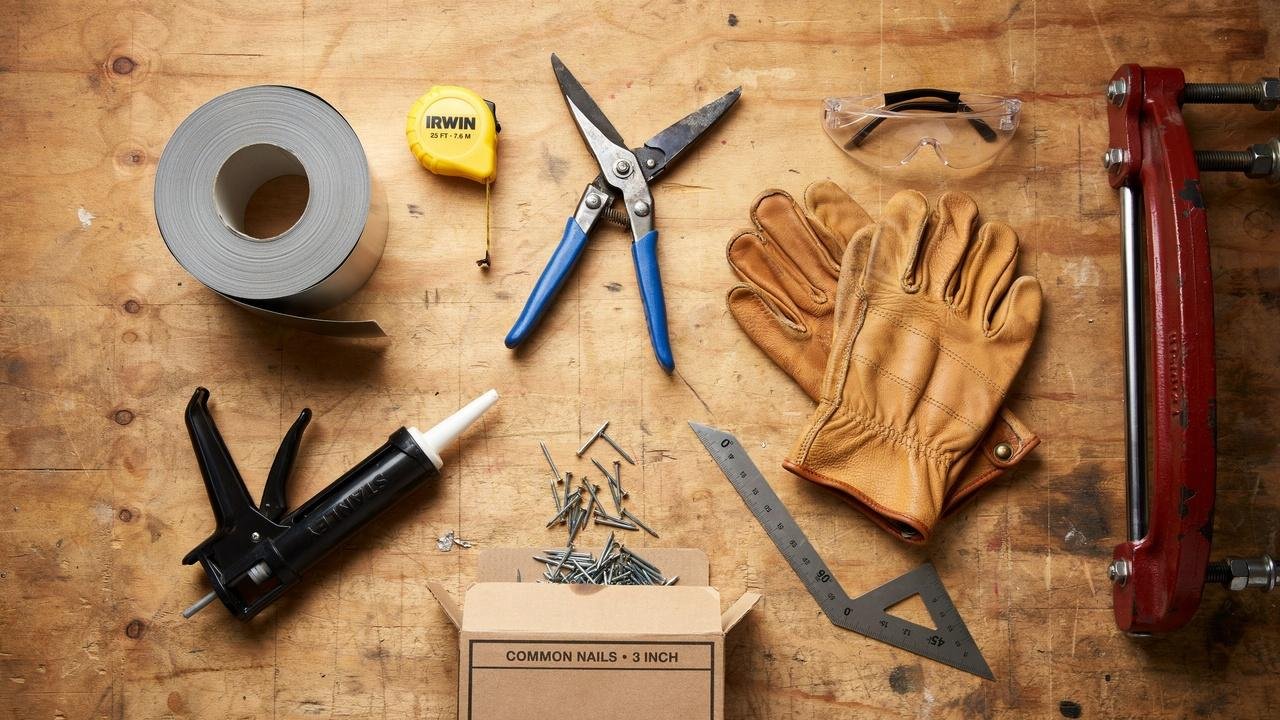 Tools and materials needed for aluminum window capping laid out on a workbench.