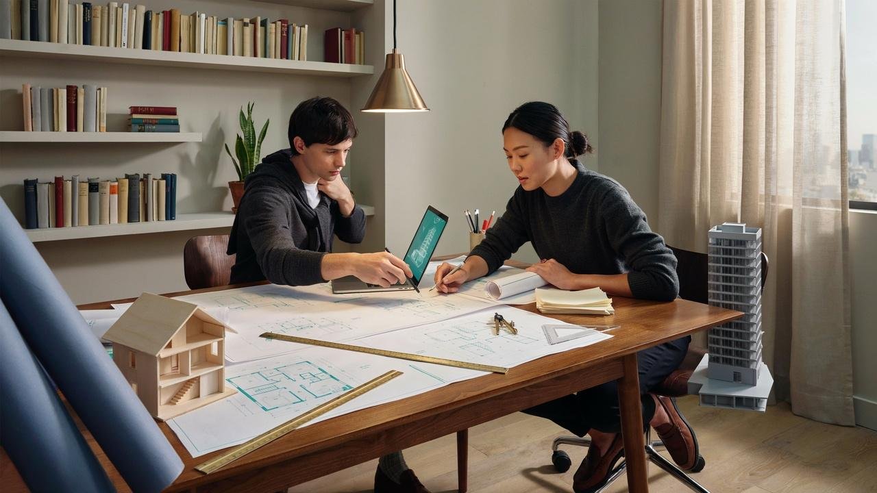 Architect comparing residential home and commercial building blueprints.
