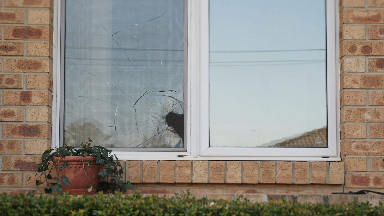Comparison of damaged and newly replaced window glass in a residential home.