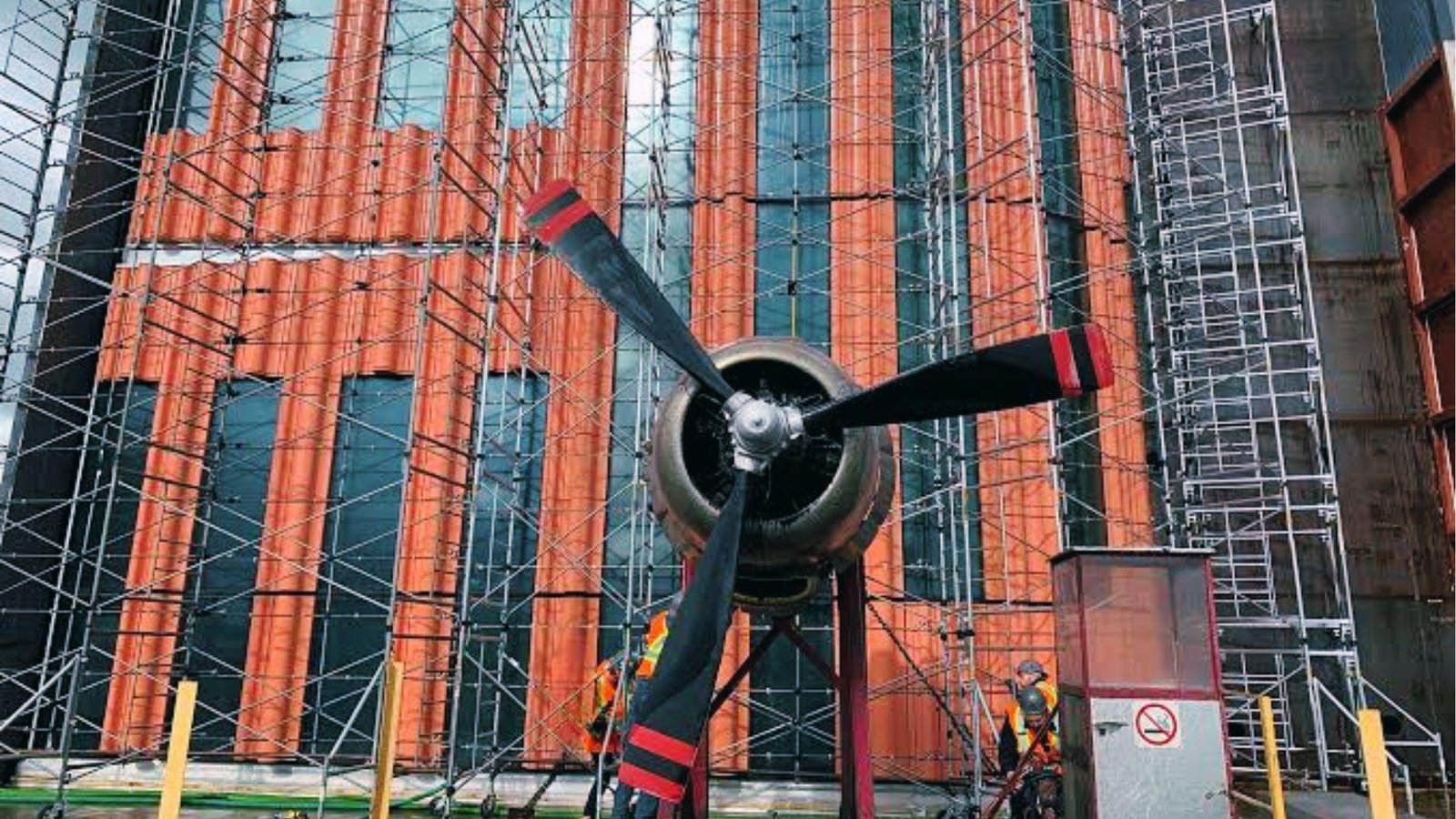 Aircraft propeller simulates wind pressure on the terracotta facade during building envelope air test.