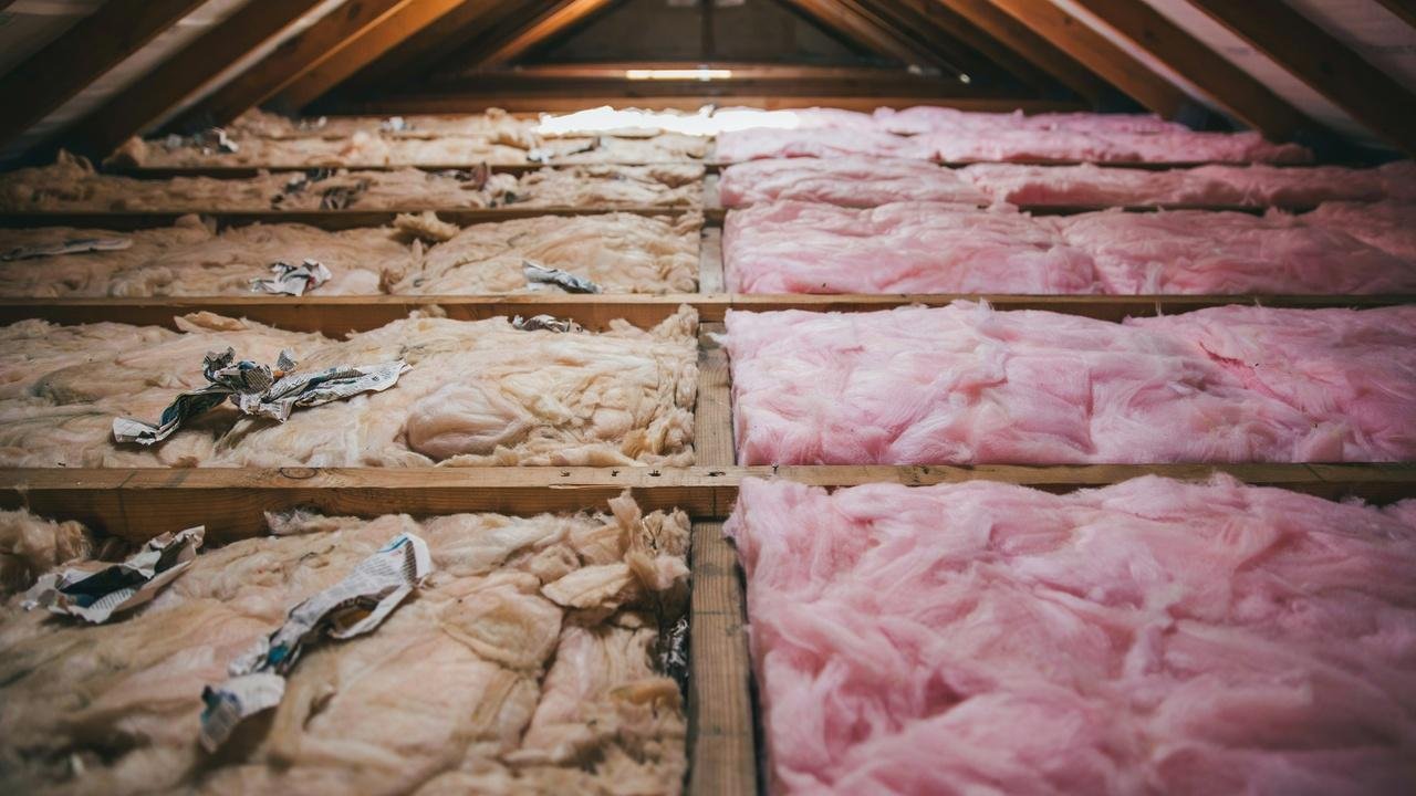 Comparison of cellulose insulation and fiberglass insulation in an attic.