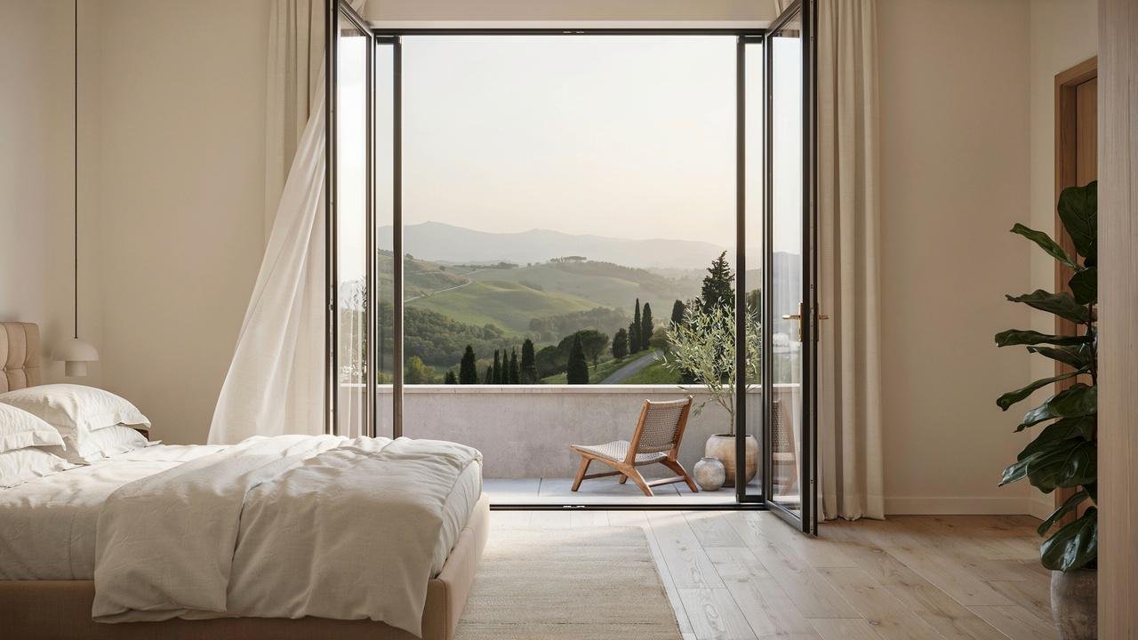 French doors opening onto a balcony with scenic views.